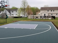 Dark green and grey backyard basketball court in Agawam, MA.