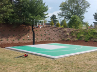 Backyard basketball court in Bridgewater, MA. We could install backyard basketball for you, too, in nearby Rhode Island locations like Middletown, Jamestown, Johnston, Cranston, Tiverton, and Woonsocket.