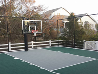 Backyard basketball court in Plymouth, MA. Whatever your sport, you could have a court surface and accessories of your own in Dover, Bedford, Cambridge, Acton or Burlington.