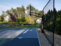 Backyard basketball court featuring a rebounder in Duxbury, MA.