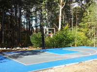 Backyard basketball court in Canton, MA. Whatever your sport, you could have a court surface and accessories of your own.