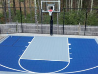 Half court with basketball hoop and rebound fence in Kingston, MA
