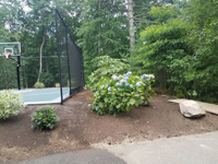 Backyard basketball court multicourt with added tennis and volleyball net in Kingston, MA.