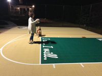 Testing out the night lighting of a tan and green basketball court in Londonderry, NH.