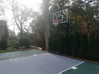 Custom rounded backyard basketball court in Needham, MA.