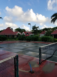 Sad Caribbean tennis court before restoration at Sandals Grande Antigua Resort and Spa in St. Johns, Antigua. Does your court look like this? Get it restored.