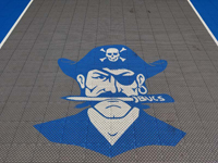 Close-up of custom pirate logo on small basketball court in Bedford, MA.