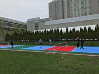 People trying out the new pickleball court at Lawn on the D in Bosot, with Westin Hotel in the background.