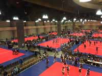 Volleyball courts in use in convention center for New England Regional Volleyball Association (NERVA) Winterfest 2020 tournament in Hartford, CT, featuring Versacourt indoor sport tile.