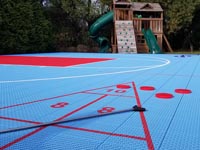 Low view across three color basketball court with added shuffleboard and accessories in Dartmouth, MA.