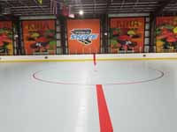 We traveled to Kapolei, Hawaii and inside to resurface two inline skate hockey rinks with Versacourt Speed Indoor tile. This shows much of the center line and the faceoff circle on the finished rink.