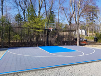 Gray and blue backyard basketball court in Middleton, MA.