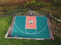 Middleton backyard basketball court in ghreen and rust from above.