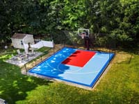 Aerial view of completed residential North Attleboro basketball court in red and two shades of blue.