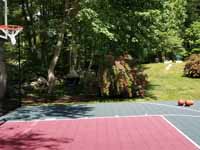 Residential slate green and red basketball court in Norwell, MA.