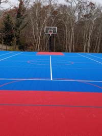 Large red and blue multicourt with basketball and net games in Plymouth, MA.
