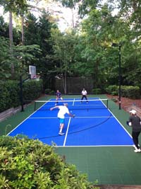 Royal blue and green tiles in use for pickleball, with multicourt option of basketball, plus optional lighting for night play.