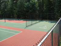Restoration and resurfacing of large tennis court into multicourt with pickleball, hopscotch and shuffleboard for a condo complex in Duxbury, Massachusetts. Also visible here is an area lined for pickleball and equipped with net posts.