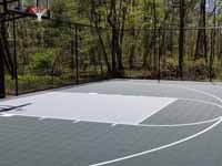 Backyard basketball court, in Versacourt slate green and titanium, in Stow, MA.