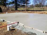 Photo from installation of a sand and emerald green residential backyard basketball court in Swampscott, MA. Last step is to pour and smooth cement that will become a reinforced concrete base for the court tiles.