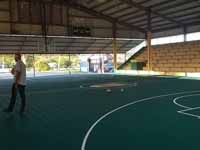 Resurfaced ABBA (Antigua and Barbuda Basketball Association) basketball court and replaced hoops at JSC Sports Complex in Piggotts, Antigua and Barbuda. Shown before resurfacing started, looking across court.